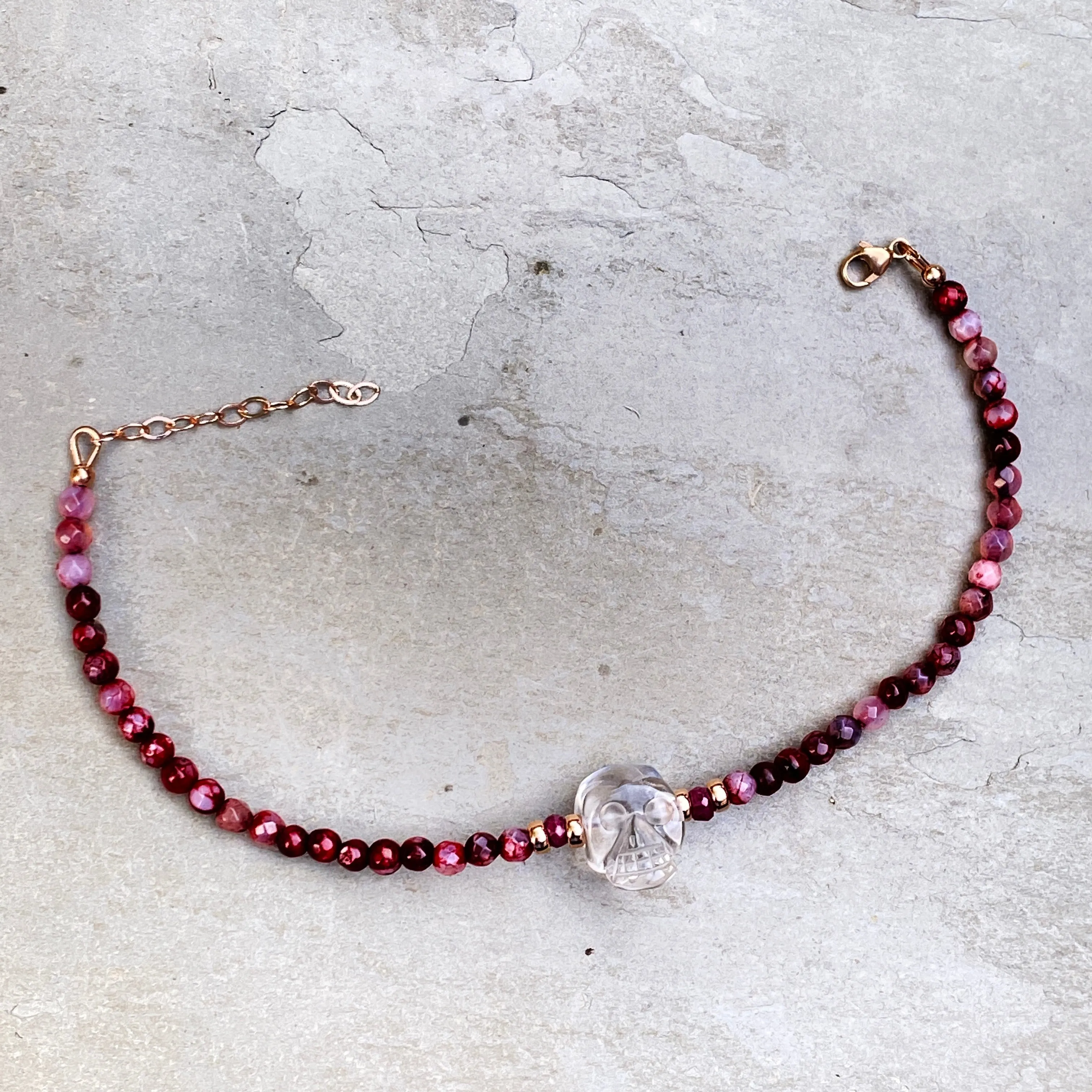 Clear quartz gemstone Skull with Rubies and fire agates and 14 kt rose gold