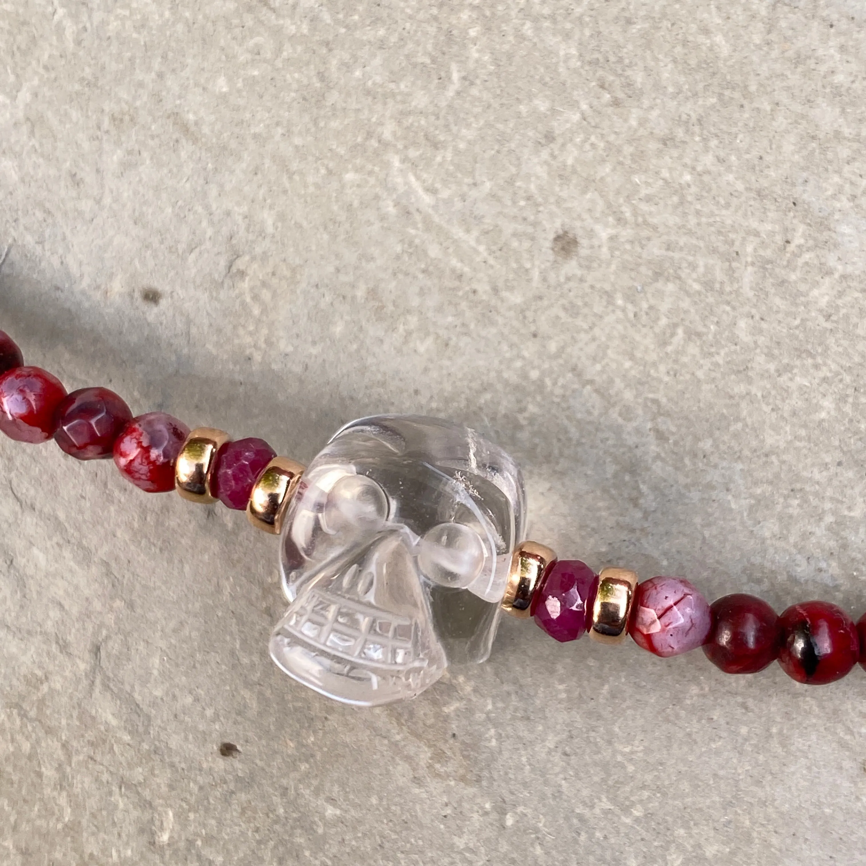 Clear quartz gemstone Skull with Rubies and fire agates and 14 kt rose gold